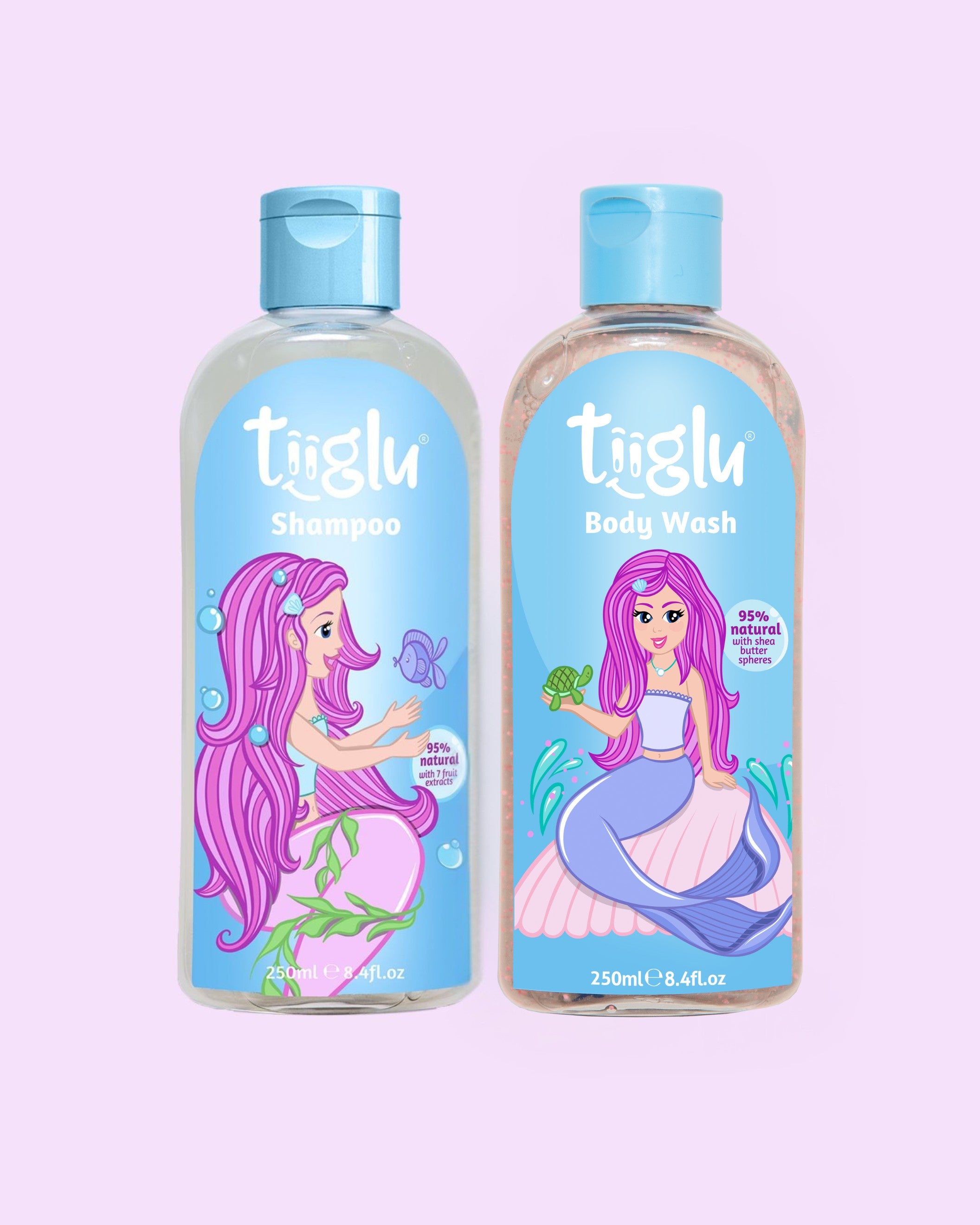 Tiiglu® Kids Mermaid Glimmer Set with Shampoo (95% natural) and Body Wash (95% natural), each 250ml, featuring a pink-haired mermaid on light blue labels, jumping jelly beans-scented, on a light pink background.