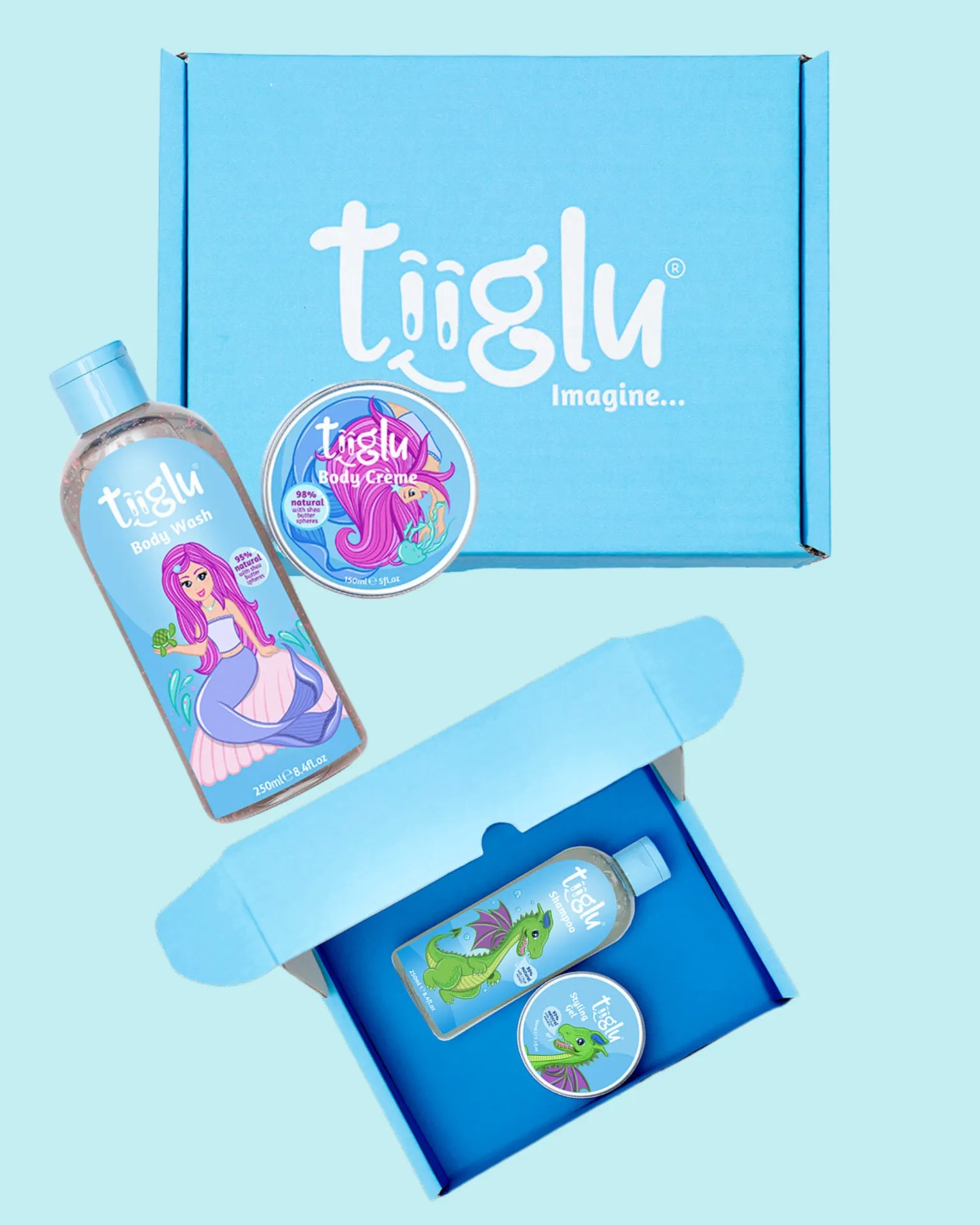 A blue Tiiglu® gift box is open, displaying body wash, shampoo, and crèmes with dragon and mermaid designs, against a light blue background. This Gifting section on the home page promotes gorgeous gifting for kids.