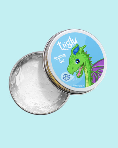 Tiiglu® Kids Dragon Styling Gel (100ml) in an open tin with clear, fragrance-free gel. Label has a green dragon on light blue, &
