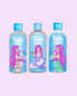 Tiiglu® Kids Mermaid Dazzle Set with Shampoo (95% natural), Body Wash (95% natural), and Conditioner (97% natural), each 250ml, featuring a pink-haired mermaid on light blue labels, jumping jelly beans-scented, on a light pink background.