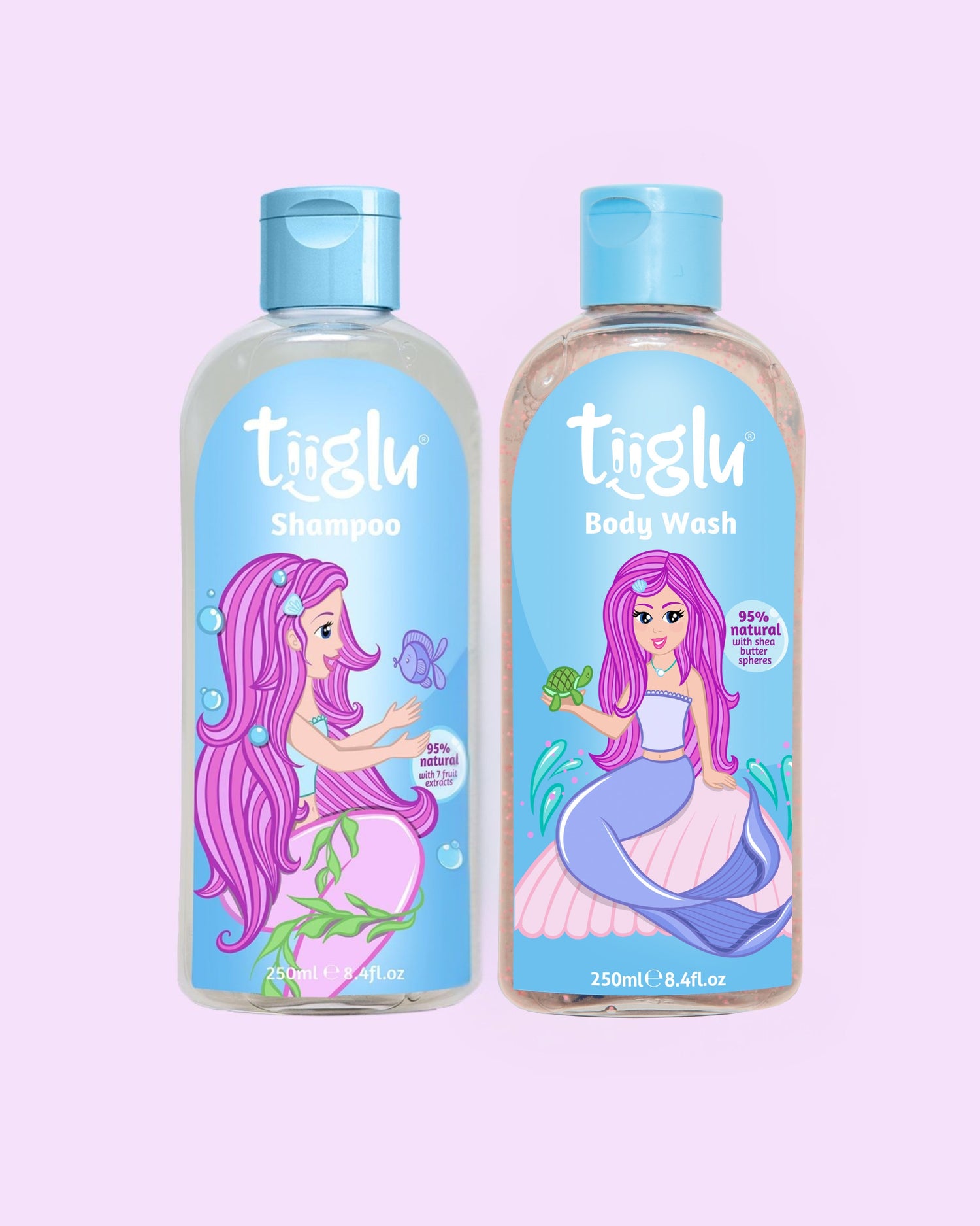 Tiiglu® Kids Mermaid Glimmer Set with Shampoo (95% natural) and Body Wash (95% natural), each 250ml, featuring a pink-haired mermaid on light blue labels, jumping jelly beans-scented, on a light pink background.