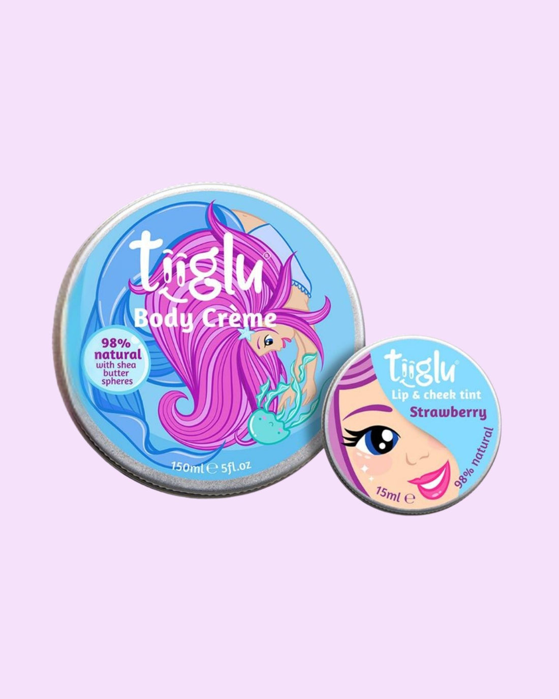 Tiiglu® Kids Mermaid Twinkle Set with Body Crème (150ml) and Lip &amp; Cheek Tint (15ml), both 98% natural, featuring a pink-haired mermaid and face on light blue labels, jumping jelly beans and strawberry-scented, on a light pink background.